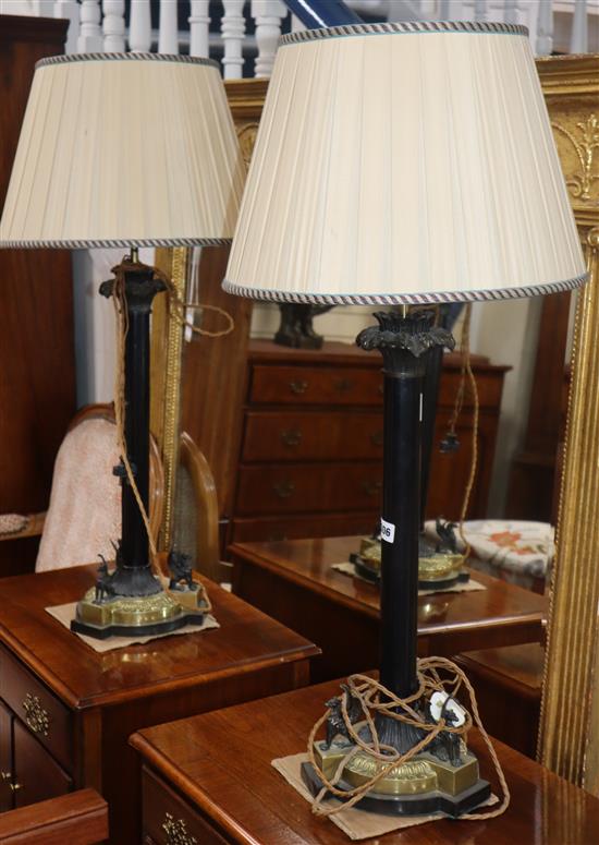 A pair of Regency style bronze and brass table lamps, decorated with three griffins to the base